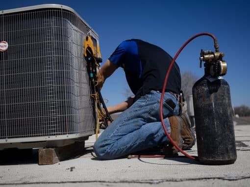 Technician testing an outdoor AC unit